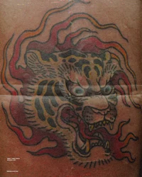a tattoo of a tiger with flames on it